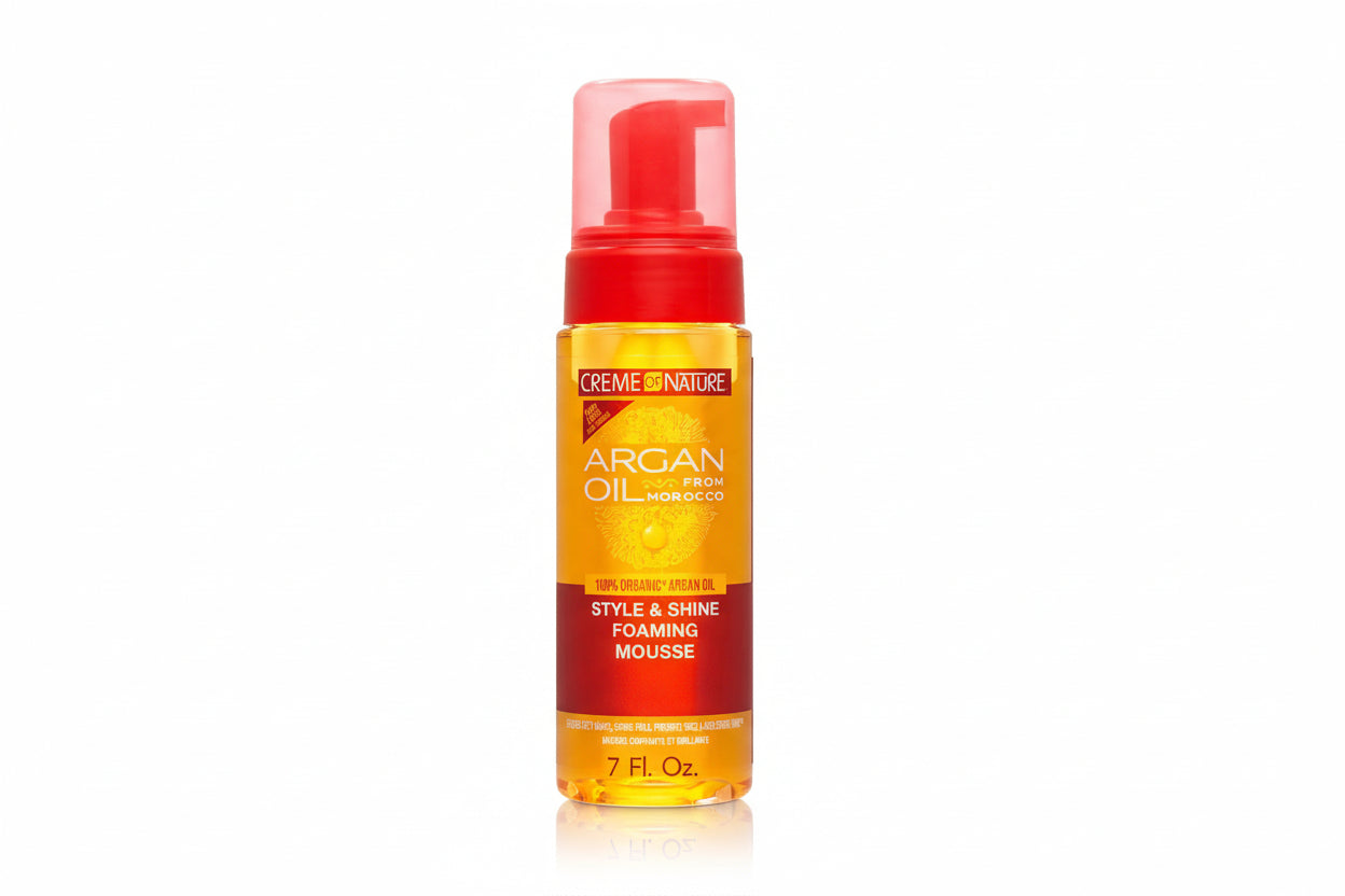 Creme of Nature Argan Oil foaming mousse bottle with red cap and orange label.