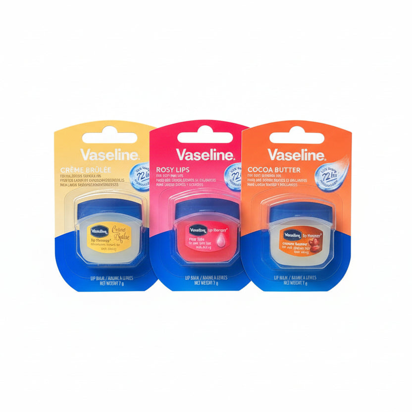 Three Vaseline lip balm containers on a dark surface