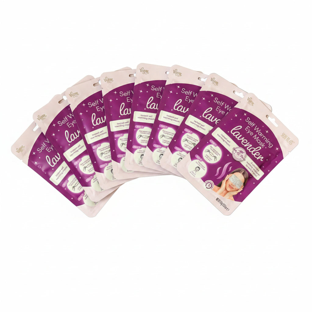 Multiple packages of self-warming eye masks with lavender scent on a dark surface.
